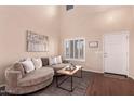 Bright living room featuring a plush couch, modern decor, and a welcoming entrance, creating a cozy and stylish atmosphere at 6512 W Eagle Talon Trl, Phoenix, AZ 85083