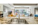 Granite countertop kitchen island, double sink, and modern appliances at 7131 E Rancho Vista Dr # 3002, Scottsdale, AZ 85251