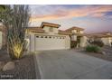 House exterior showcasing a two-car garage and well-maintained landscaping at 10048 E Emerald Dr, Sun Lakes, AZ 85248