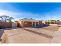 Front view of a single story home with a large driveway at 1061 W 5Th St, Mesa, AZ 85201