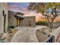 Elegant home entrance with stonework and a paved pathway at 10639 E Fernwood Ln, Scottsdale, AZ 85262