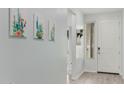 Bright entryway with light walls, wood-look floors, and cactus art at 1094 S 151St S Ln, Goodyear, AZ 85338