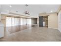 Open living area with tile flooring and a barn door at 12451 N Cherry Hills E Dr, Sun City, AZ 85351