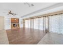 Living room with fireplace, built-in shelving, and wood-look tile floors at 12451 N Cherry Hills E Dr, Sun City, AZ 85351