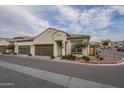 Tan two-car garage home with brown doors and landscaping at 1255 N Arizona Ave # 1109, Chandler, AZ 85225