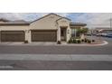 Tan two-car garage home with brown doors and landscaping at 1255 N Arizona Ave # 1109, Chandler, AZ 85225