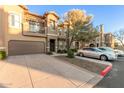 Tan two-story townhome with attached garage at 14250 W Wigwam Blvd # 2121, Litchfield Park, AZ 85340