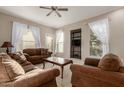 Bright living room with brown couches and a coffee table at 14250 W Wigwam Blvd # 2121, Litchfield Park, AZ 85340