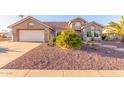 Single-story home with desert landscaping and a two-car garage at 14316 W Circle Ridge Dr, Sun City West, AZ 85375