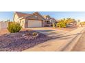 Front view of a single story home with gravel driveway and landscaping at 14316 W Circle Ridge Dr, Sun City West, AZ 85375