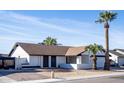 Single story home with desert landscaping and a gated entrance at 1437 W Ross Ave, Phoenix, AZ 85027