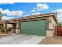 Home exterior showcasing green garage door and landscaping at 163 W Dragon Tree Ave, Queen Creek, AZ 85140