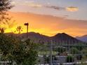 Sunset view of community amenities with mountains in the background at 16833 S 177Th Ln, Goodyear, AZ 85338