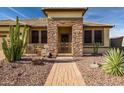 Front entrance with stone accents and walkway leading to the home at 17164 S 174Th Dr, Goodyear, AZ 85338