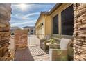 Relaxing patio area with wicker chairs and stone accents at 17164 S 174Th Dr, Goodyear, AZ 85338