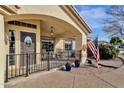 Covered porch with a decorative door and American flag at 1902 E Bruce Ave, Gilbert, AZ 85234