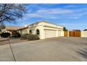 Two-car garage with wood doors and a long driveway at 1902 E Bruce Ave, Gilbert, AZ 85234