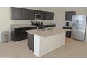 Spacious kitchen with granite island and dark cabinets at 19203 N Marbella Ave, Maricopa, AZ 85138