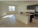 Open concept kitchen with granite island and stainless steel appliances at 19203 N Marbella Ave, Maricopa, AZ 85138