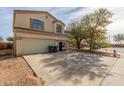 Two-story house with a double garage and spacious driveway at 2016 N Ensenada Ln, Casa Grande, AZ 85122