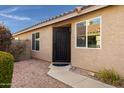 Dark brown metal front door with decorative accents at 2023 E Glenhaven Dr, Phoenix, AZ 85048