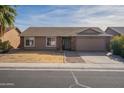 Single-story house with attached garage and desert landscaping at 2057 E Brooks St, Gilbert, AZ 85296