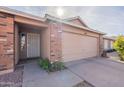 House exterior featuring a brick facade and attached garage at 2057 E Brooks St, Gilbert, AZ 85296