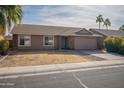 Single-story house with attached garage and desert landscaping at 2057 E Brooks St, Gilbert, AZ 85296