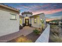 Attractive house entrance and landscaped front patio featuring desert plants and mountain view at 20641 W Medlock Dr, Buckeye, AZ 85396