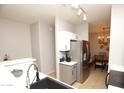 View of kitchen, stainless steel refrigerator, and dining area at 2150 W Alameda Rd # 1037, Phoenix, AZ 85085