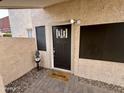 Front entry with dark door, welcome mat and owl statue at 2168 E Sanos Dr, Tempe, AZ 85281