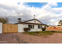 House exterior with wood gate and rock landscaping at 2614 E Mountain View Rd, Phoenix, AZ 85028