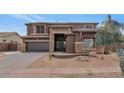 Two-story home with stone accents and a three-car garage at 2739 W Via Bona Fortuna Dr, Phoenix, AZ 85086