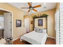 Guest bedroom with wood floors, a murphy bed, and access to private patio at 29432 N 128Th Ln, Peoria, AZ 85383