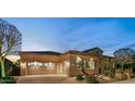 Evening view of home's exterior, showcasing garage and landscaping at 29432 N 128Th Ln, Peoria, AZ 85383