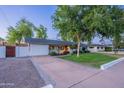 Charming single-story home with a well-manicured lawn and mature trees offering great curb appeal at 3002 E Mitchell Dr, Phoenix, AZ 85016