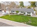 Expansive front yard with mature landscaping and charming curb appeal at 3002 E Mitchell Dr, Phoenix, AZ 85016