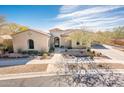 One-story house with desert landscaping, driveway, and a three-car garage at 32807 N 15Th Gln, Phoenix, AZ 85085