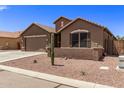 House with a two-car garage, cactus, and desert landscaping at 35134 N Laredo Dr, San Tan Valley, AZ 85144