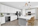 Spacious kitchen with white cabinetry, island, and modern appliances at 37762 N Poplar Rd, San Tan Valley, AZ 85140