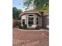 View of the front entrance, featuring a charming, desert-style landscaped front yard and covered entryway at 4043 E Arbor Ave, Mesa, AZ 85206