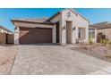 Modern home exterior showcasing a brown garage door and a brick driveway at 42223 N Golden Trl, San Tan Valley, AZ 85140