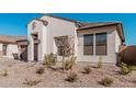 Single-story home with modern design, landscaped front yard, and two-car garage at 42223 N Golden Trl, San Tan Valley, AZ 85140