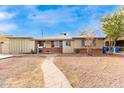 Ranch style home with walkway leading to the front door at 4405 W Clarendon Ave, Phoenix, AZ 85031