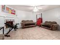 Cozy living room featuring a fireplace and tiled floors at 4405 W Clarendon Ave, Phoenix, AZ 85031