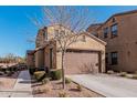 Tan two-story house with a brown garage door and tree at 4777 S Fulton Ranch Blvd # 1027, Chandler, AZ 85248