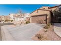 Tan house with a brown garage door and driveway at 4777 S Fulton Ranch Blvd # 1027, Chandler, AZ 85248