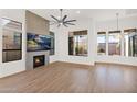 Bright living room featuring a fireplace and large windows at 4835 E Daley Ln, Phoenix, AZ 85054