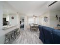 Bright dining area with wood-look floors and a view of the living room at 4850 E Desert Cove Ave # 132, Scottsdale, AZ 85254