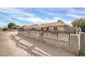 House exterior showcasing a long driveway and block wall at 7337 W Claremont St, Glendale, AZ 85303